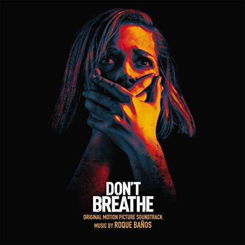 A woman with a terrified expression covers her mouth against a dark background.