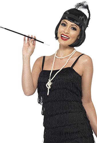 A woman in a 1920s flapper costume holds a cigarette holder, wearing a black fringe dress.