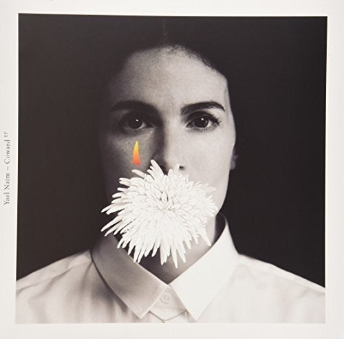 Black and white portrait of Yael Naim with a flower over her mouth.