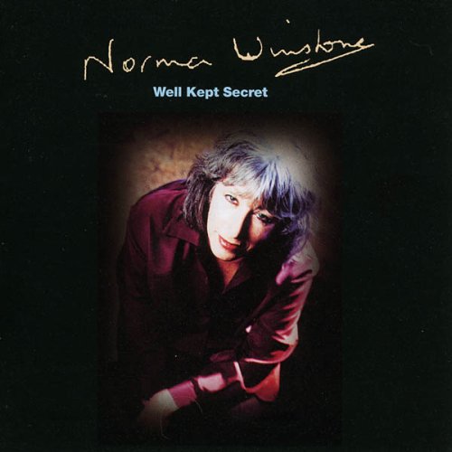 "CD cover with Norma Winstone crouching, wearing a dark shirt, against a black background."