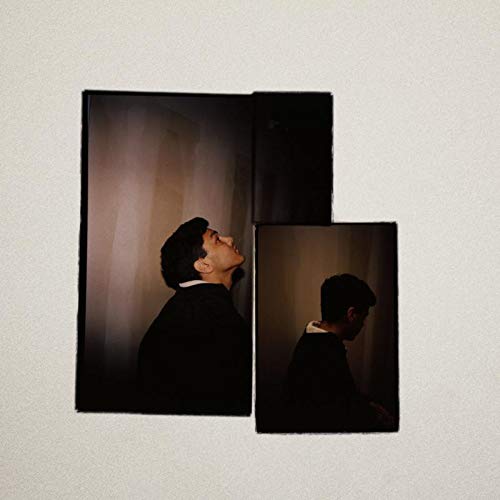 "Vinyl record and booklet featuring a man in a black jacket."