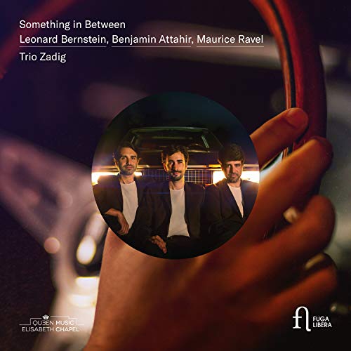 "CD cover with three men in suits inside a steering wheel."