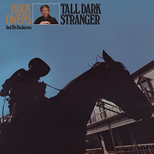 Album cover for Buck Owens’ “Tall Dark Stranger” featuring a cowboy on horseback.