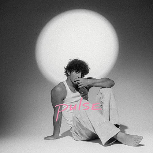 Black and white portrait of Benson Boone with pink “PULSE” text.