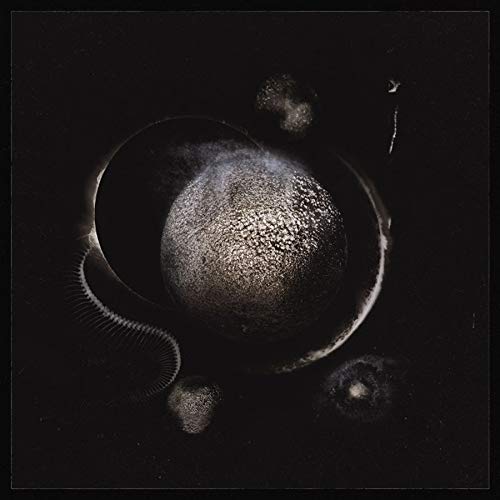 Dark album cover featuring a textured, spherical planet in space.