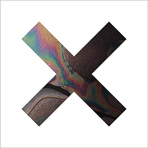 Iridescent X shape against a white background, album cover art.