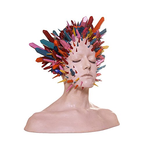 Head sculpture with colorful, crystalline spikes protruding from face and hair.