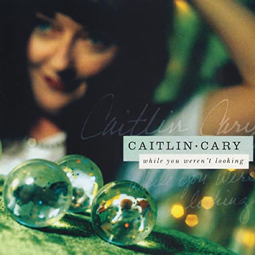 Album cover for Caitlin Cary’s “While You Weren’t Looking” with marbles.