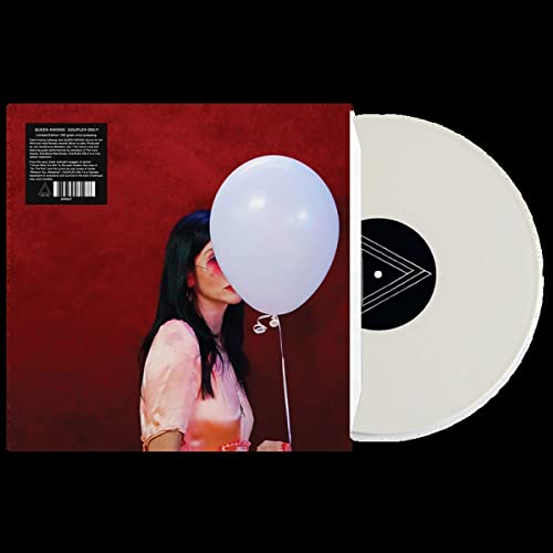 Vinyl record with a woman holding a white balloon against a red background.