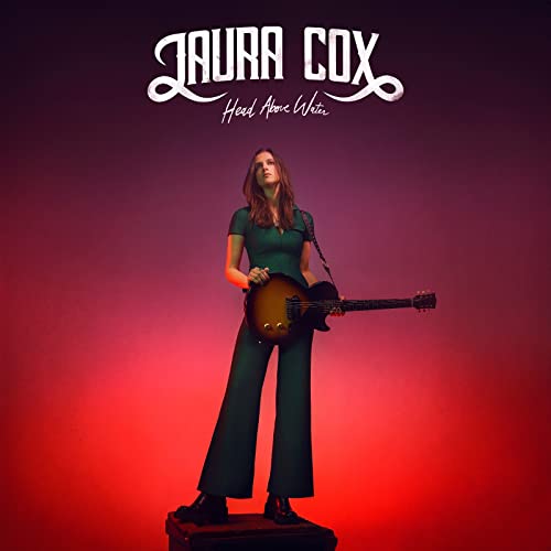 Album cover for Laura Cox’s “Head Above Water” featuring a woman with a guitar.