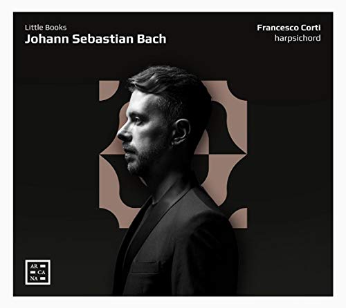CD cover featuring a man in a suit against a black background with ornate design.