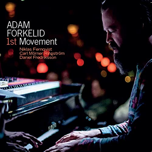 CD cover featuring pianist Adam Forkelid with blurred background lights.