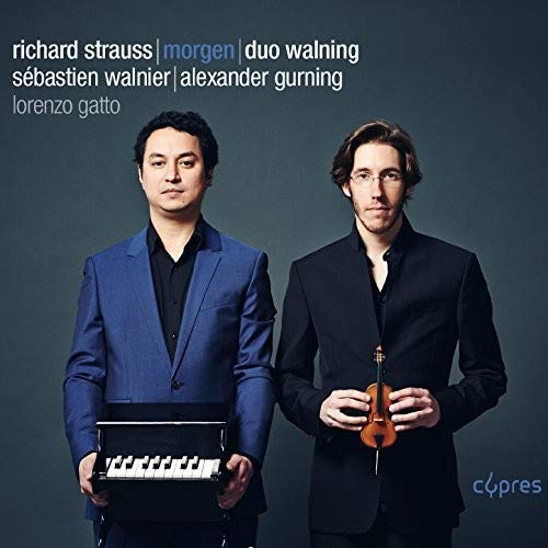 "CD cover featuring two men, one holding a keyboard and the other a violin."