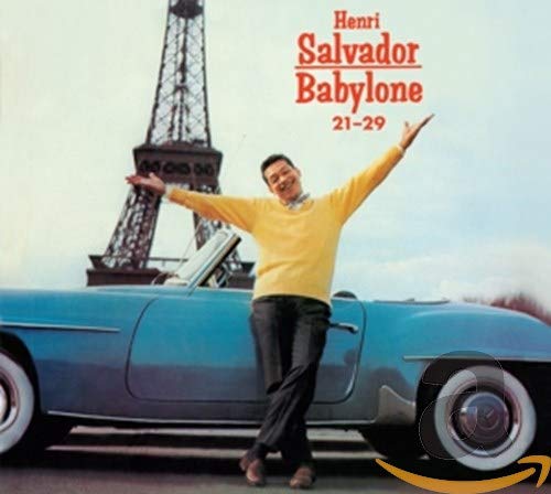 "CD cover with man standing by blue car, Eiffel Tower in the background."