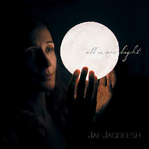 Woman holding a glowing orb with text “all is now light”.