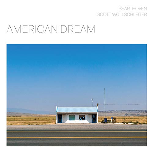 CD cover: small building on a highway under a blue sky.