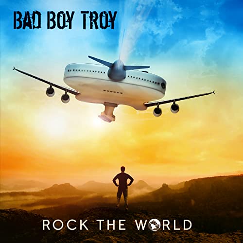 CD cover: airplane over mountains, silhouette of a person below.