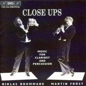 "CD cover with two men playing clarinet and percussion on white platforms."