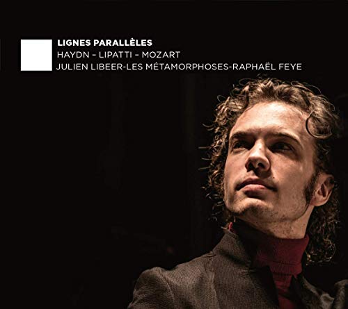 "CD cover featuring a man with curly hair against a black background."