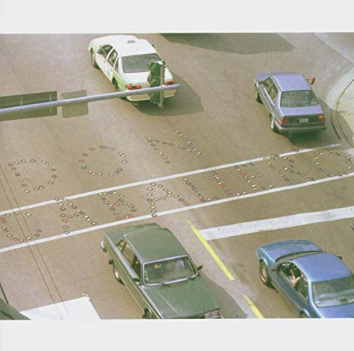 Overhead view of cars on a highway with painted marker shapes.