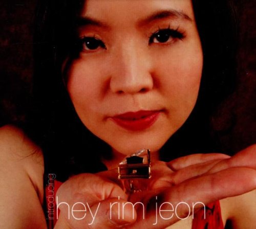 A woman holds a CD jewel case, with "hey rim jeon" text overlay.