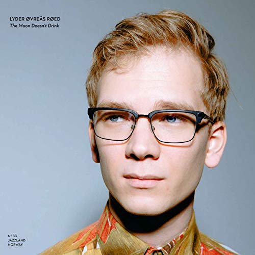Album cover featuring a man with blond hair and glasses against a gray background.