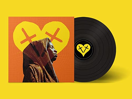 Vinyl record with album cover featuring a person and heart design.