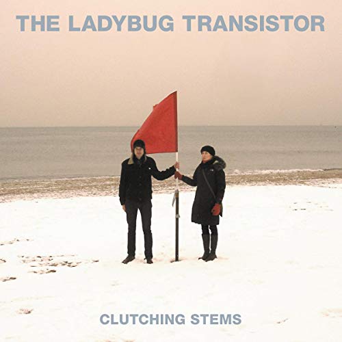 CD cover: two figures with a red flag on a beach.