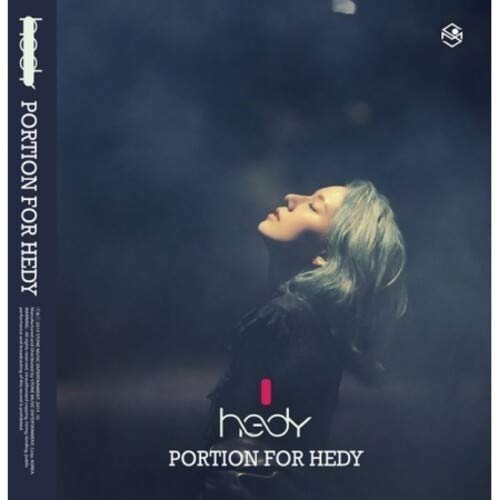 The image is a CD cover for "Portion for Hedy" by Hedy. * The cover features a woman with long hair, wearing a dark top, gazing upwards. * The background is dark and blurry, with a blue hue. * The title "Portion for Hedy" is written in white text at the bottom. * The artist's name "hedy" is displayed prominently above the title. A suitable alt text for this image could be: "CD