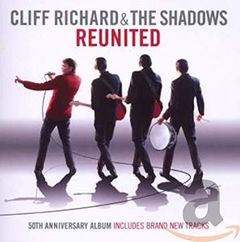 Cliff Richard and The Shadows standing on a stage with instruments against white background.