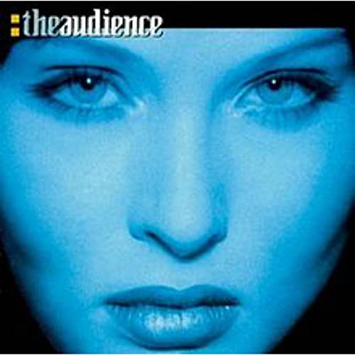 Close-up of a woman’s face in blue tones, album cover art.