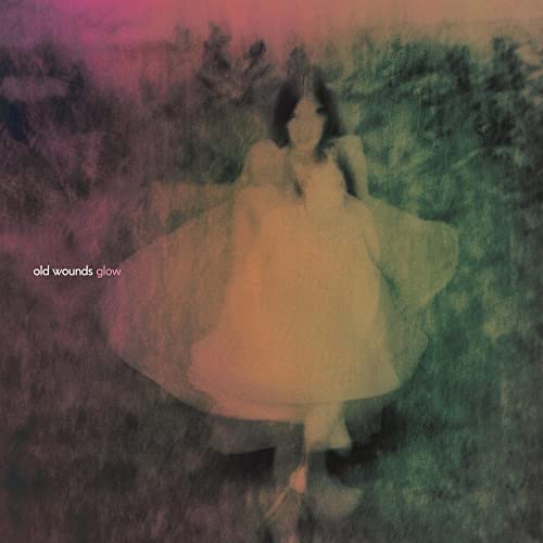 Album cover: woman in white dress in a blurred, colorful landscape.