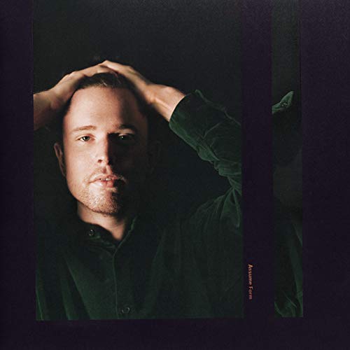James Blake album cover: portrait of a man with hands in hair.