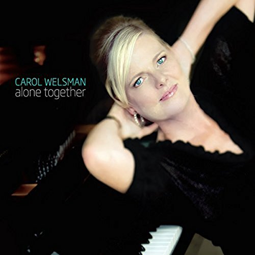 "Album cover featuring a woman in a black dress leaning on a piano."