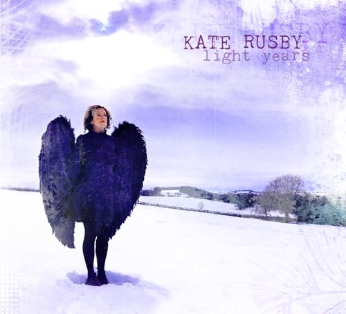 Kate Rusby album cover: woman with black wings in a snowy landscape.