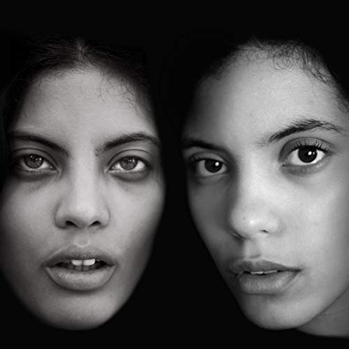 Black and white close-up portrait of two women looking directly at the viewer.