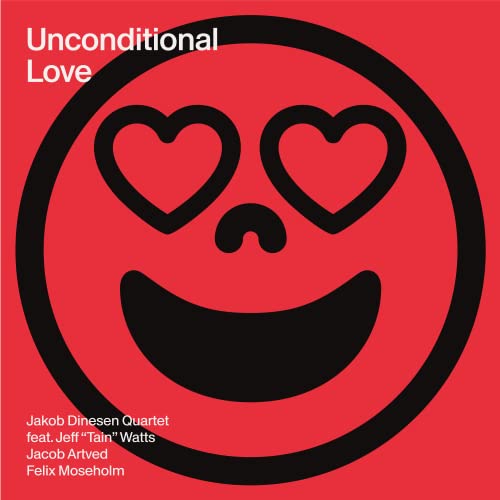 Red vinyl record cover with a black smiley face and two hearts for eyes.