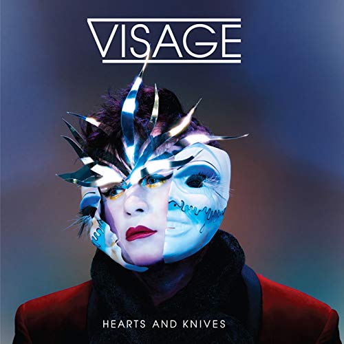 Visage album cover: person with metallic headpiece and split-face makeup.