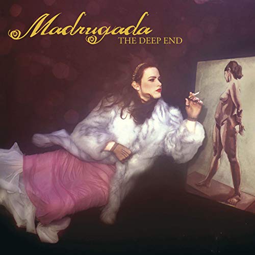 The image depicts a woman reclining on a couch, surrounded by a dimly lit atmosphere. She is dressed in a white fur coat and appears to be smoking a cigarette while gazing to her right. The background is dark, with the title "Madrugada" and subtitle "The Deep End" visible at the top. The overall mood of the image is moody and introspective.