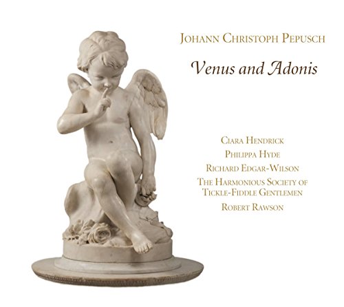 A marble statue of a winged child on a dog beside text.