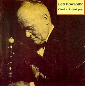 CD cover featuring sepia-toned photo of man playing pipes, with text in top-right corner.
