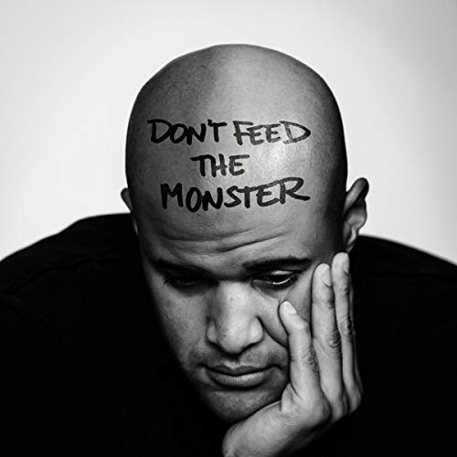 Black and white portrait of a man with text written on his head.
