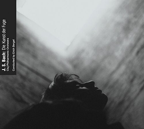 Black and white album cover featuring a reclining person’s face in shadow.