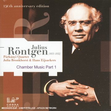 "CD cover featuring a man in a black suit with clasped hands."