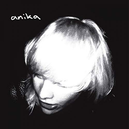High-contrast black and white portrait of a woman with the text anika above.
