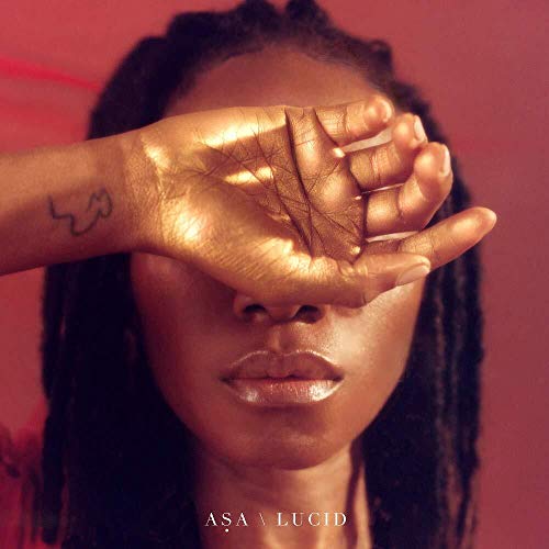 CD cover for ASA’s “LUCID” featuring a golden hand over a face.