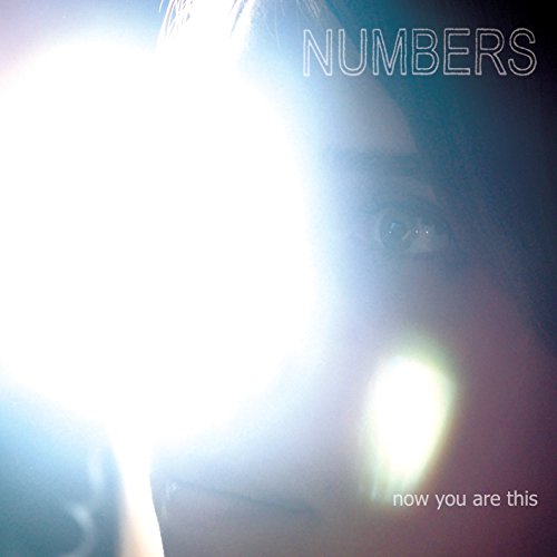 CD cover with blurred face and bright light, text "NUMBERS" and "now you are this".