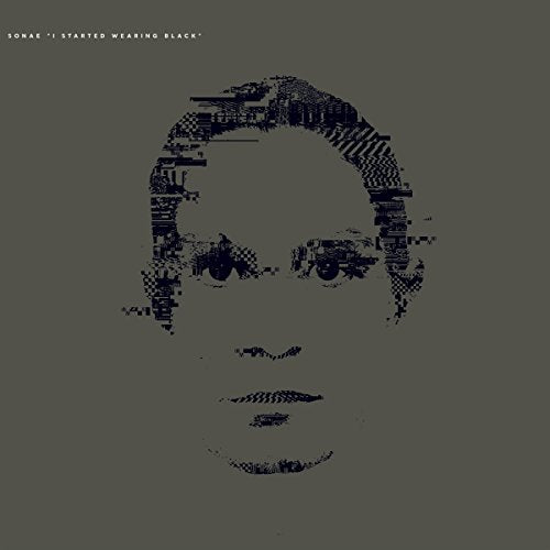 Pixelated face on a gray background with white text at the top.