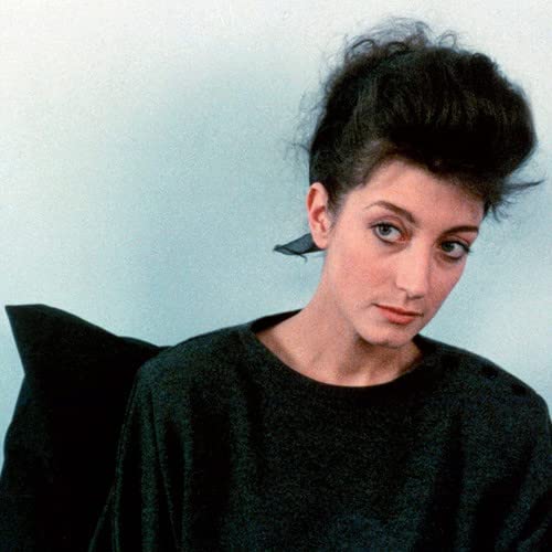 Close-up portrait of a woman with dark hair and a black top.