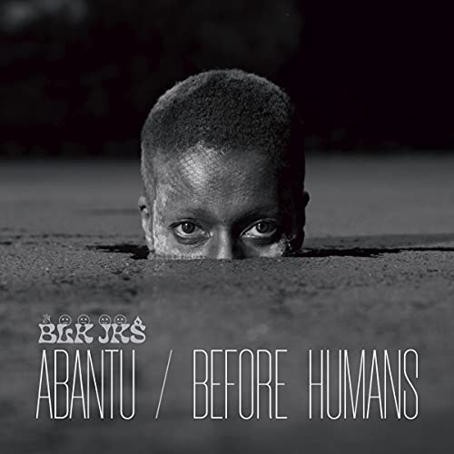 "Black and white album cover with a child's face buried in the ground."